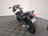 a motorcycle that is parked on a checkered floor