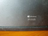 le logo Windows à l'arrière d'un ordinateur portable posé sur une table en bois