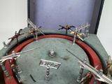 a clock with a bunch of figurines on top of it