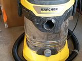 yellow and black vacuum cleaner sitting on top of a floor next to a tool