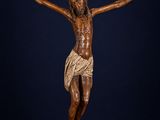 a wooden statue of jesus on the cross