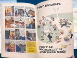 a person holding a book open to a page of comics