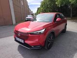 a red car parked in a parking lot next to a building