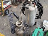 a lot of gas cans and other equipment on the ground