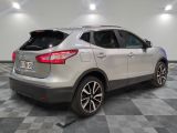 the rear end of a silver suv parked on a checkered floor