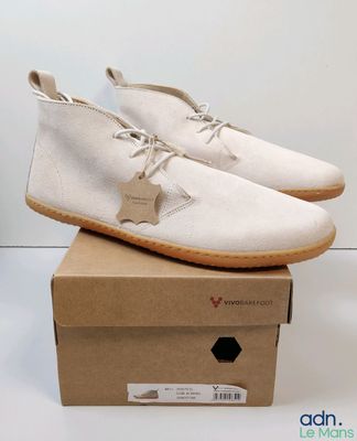 the white shoe is sitting on top of a cardboard box