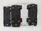 four toy cars that are lined up on a table