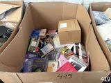a cardboard box filled with books and other items