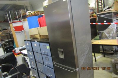 an image of a refrigerator in a warehouse with many boxes
