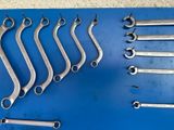 a lot of wrenches that are on a blue board