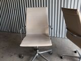two office chairs in front of a corrugated wall in a warehouse
