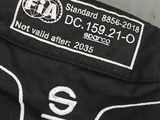a close up of a black jacket with a white label on it