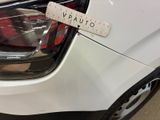 a white car with a measuring tape on it ' s headlight
