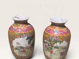 pair of chinese vases with painted scenes on them on a white background