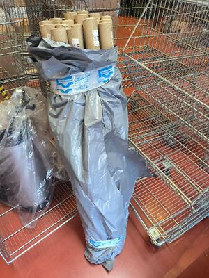 many bags of toilet paper on the floor in the store
