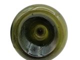 a close up of a green glass object on a white surface