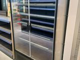 de nombreuses étagères vides dans un magasin aux portes vitrées