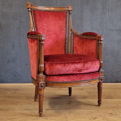 une chaise rouge posée sur un parquet en bois massif