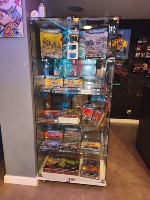 a glass display case with a lot of games on it
