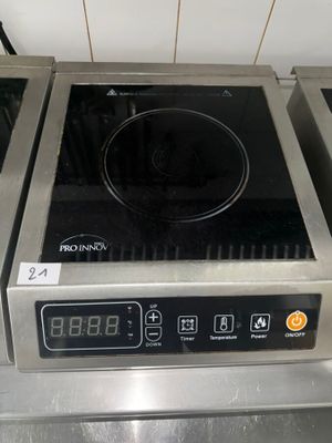 a black and silver stove top with a digital clock on it