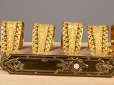 a gold bracelet that has been placed on a table