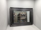 a reflection of a man taking a picture of himself in a mirror