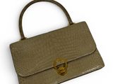 an image of a brown purse with a gold ring on the handle