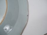 a white plate with a brown edge and a blue plate with a brown edge