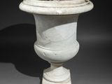 a white vase that is sitting on top of a table