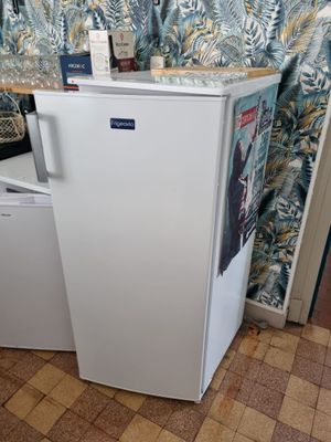 a small white refrigerator in the corner of a room