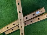 a wooden instrument that is laying on a green carpet
