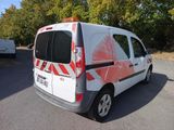a van that is parked in a lot with trees in the background