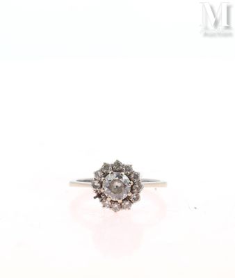 a close up of a diamond ring on a white surface