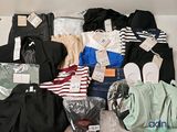 a pile of clothes and other items on a bed