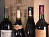 several bottles of wine are lined up on a shelf