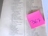 an open book with a pink sticker on it sitting on a table