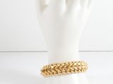 a close up of a mannequin hand with a gold chain bracelet on it