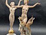 two figurines that are standing next to each other