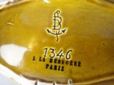 a close up of a yellow plate with an anchor on it