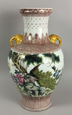 a vase with a bird and flowers painted on it