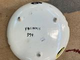 a picture of a white plate with a black and yellow marker on it