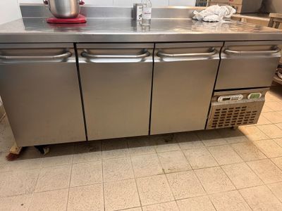 a stainless steel counter with a red bowl on top of it