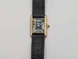 a close up of a watch on a white surface with a black strap