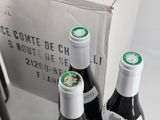 several bottles of wine are lined up on a table
