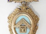 gold and blue medal with a house on it and a blue ribbon around it
