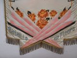 a banner hanging on the wall with flowers on it