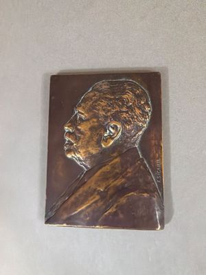 a metal plaque with a picture of a man on it