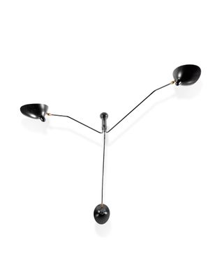 three black lamps on a white surface with a white background