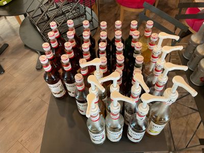 many bottles of beer sitting on a table in a room