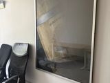 two chairs in a room with a large picture on the wall